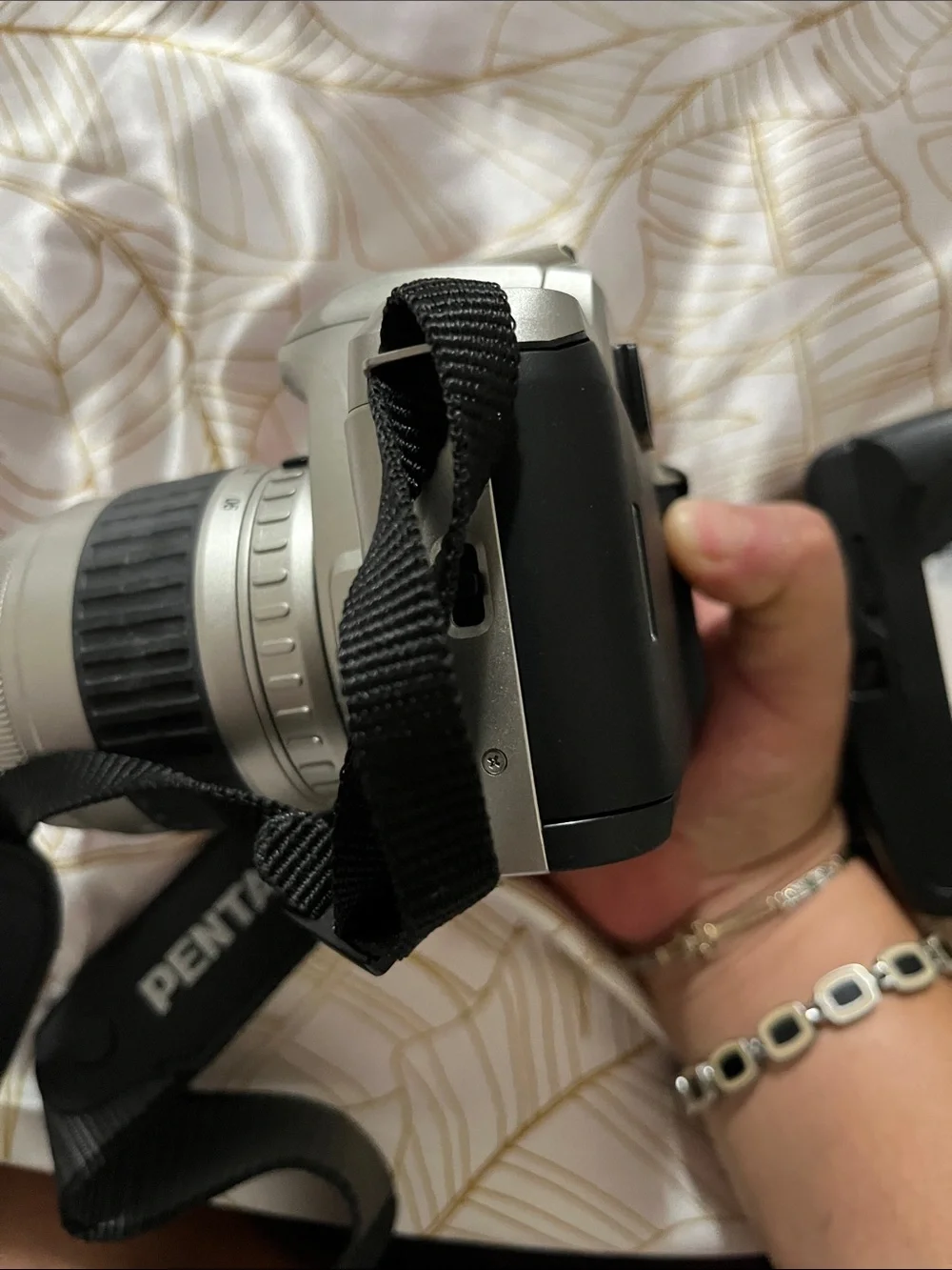 Pentax Silver and Black DSLR with 28-90mm Zoom Lens and Branded Strap